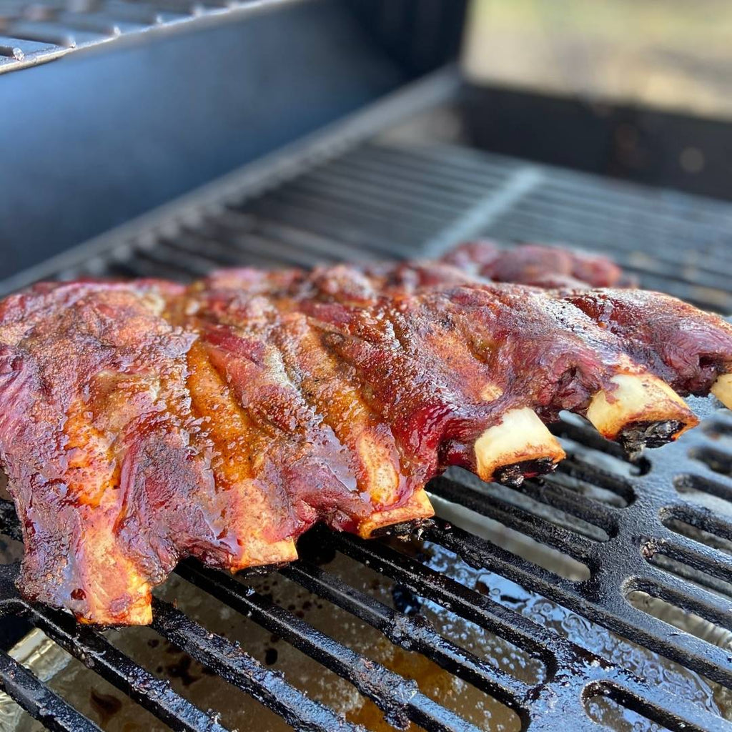Rack of cooked Bison Back Ribs on grill.
