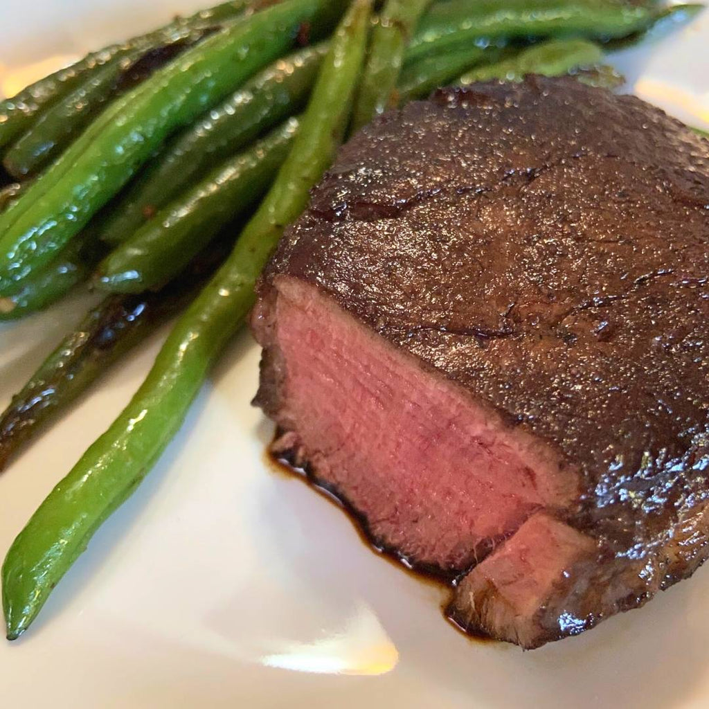 Bison Filet Mignon, cooked rare, with green beans.