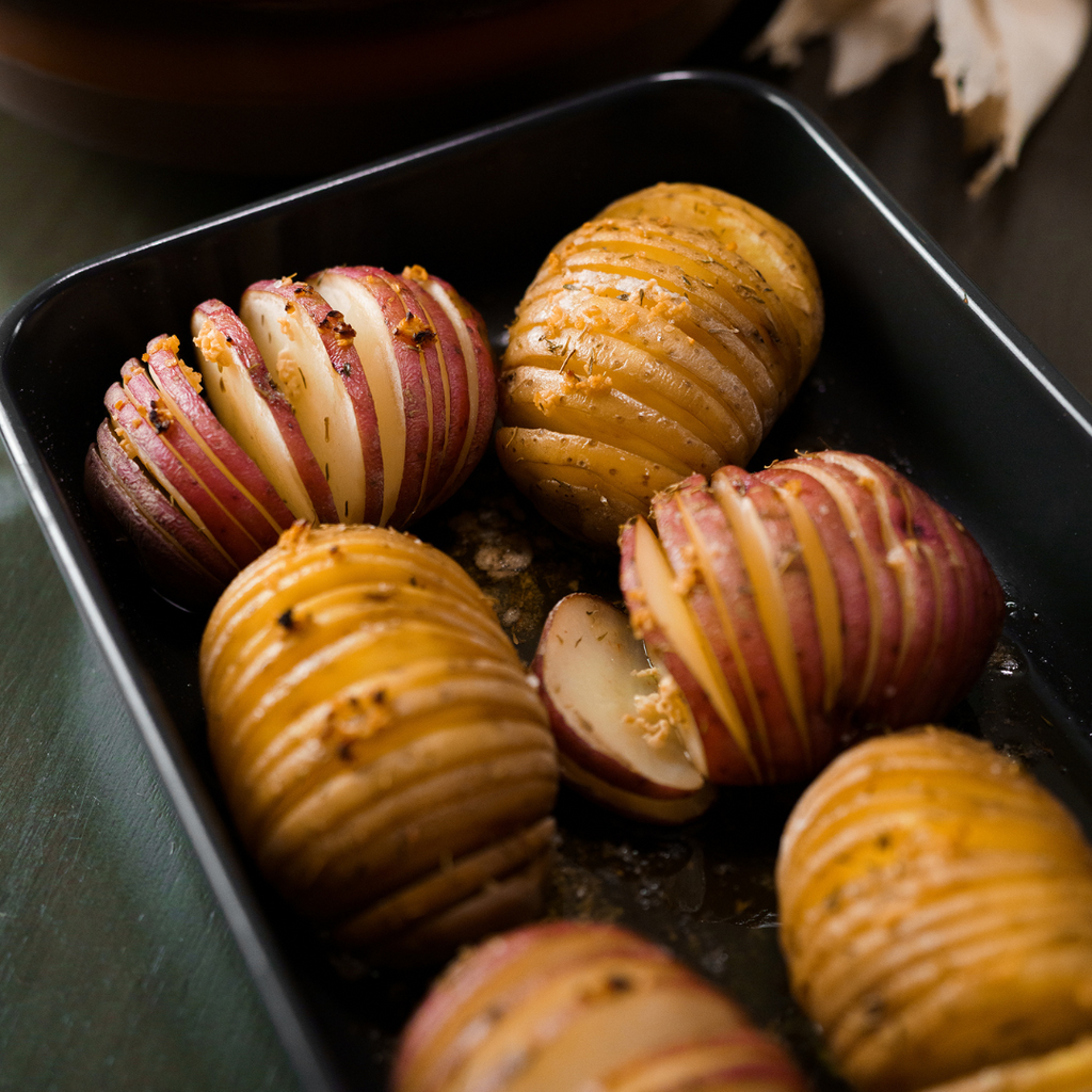 Cooked Hasselback Potatoes in pan.