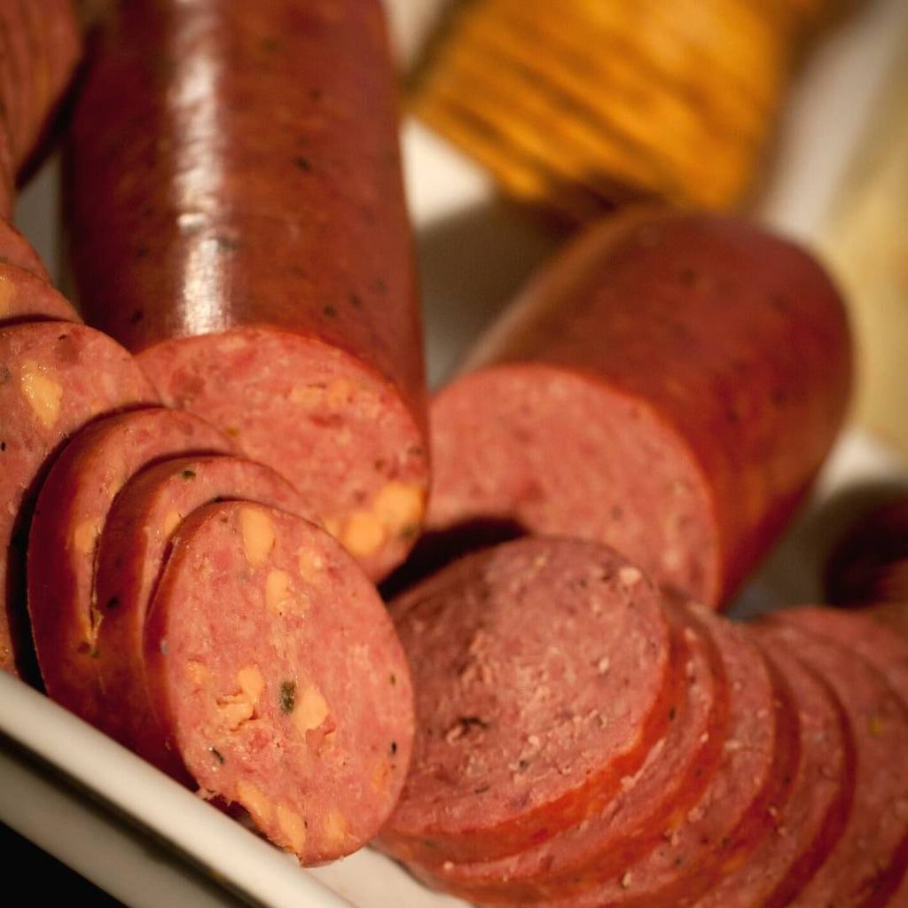 Sliced Bison Summer Sausage spread out on tray.