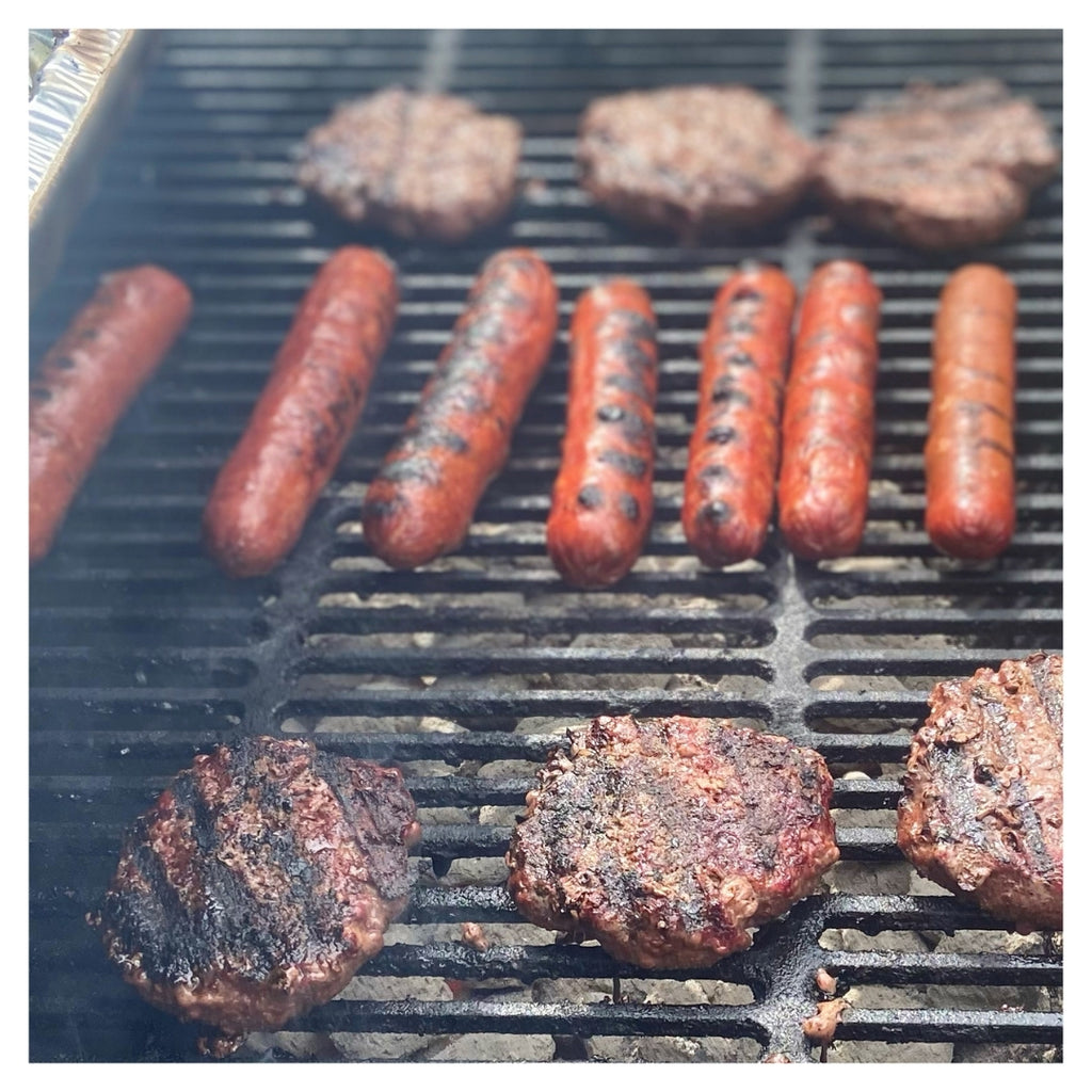 Bison burgers and hot dogs on the grill.