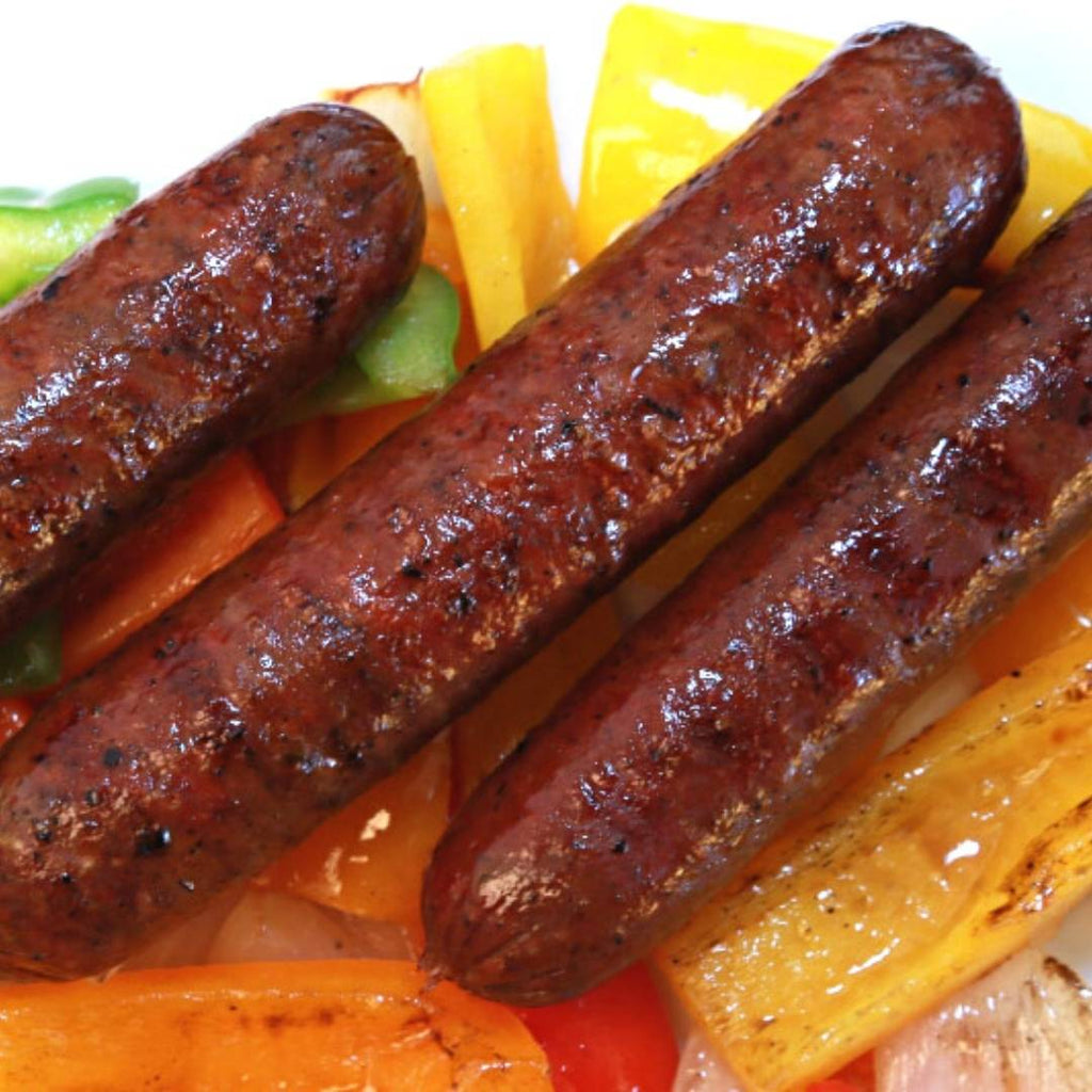 Bison Hot Italian Sausage Links on a bed of colorful peppers.