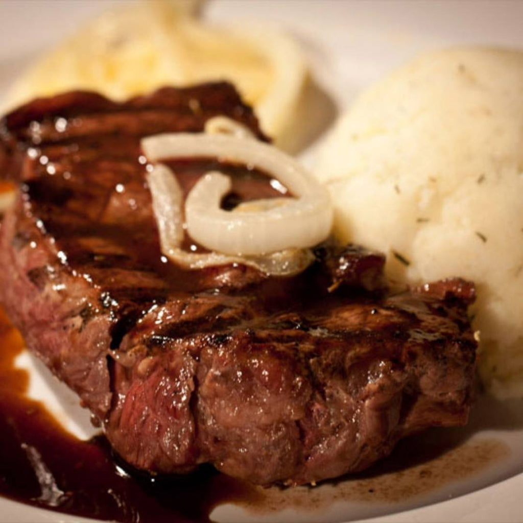 Bison Top Sirloin Cooked with sauce and mashed potatoes.
